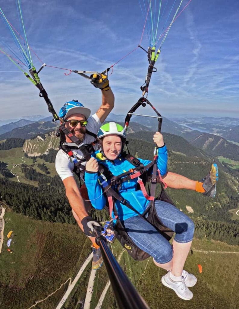 Tandem paragliding pilot in flight